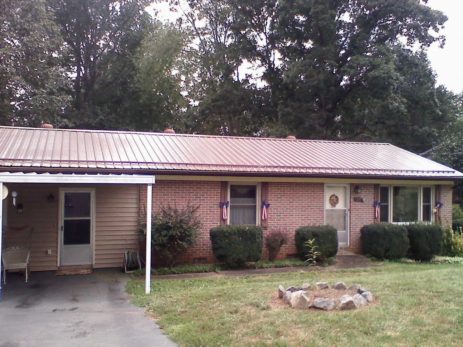 Bronze metal roof and carport on a brick ranch home — Roof Repair work by our crew in Clackamas